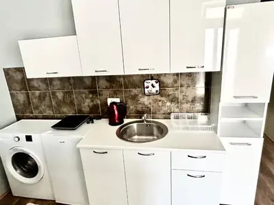 a kitchen with a sink and a washing machine at My Choice in Budva