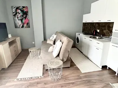 a living room with a couch and a kitchen at My Choice in Budva