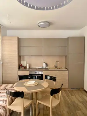 a kitchen and dining room with a table and chairs at Studio Prima-Modern Cozy Studio, 4 min to Beach in Pržno