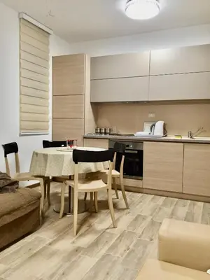 a kitchen and dining room with a table and chairs at Studio Prima-Modern Cozy Studio, 4 min to Beach in Pržno