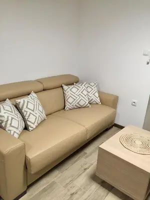 a brown couch in a living room with pillows at Studio Prima-Modern Cozy Studio, 4 min to Beach in Pržno