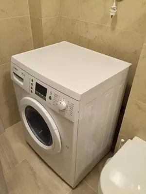 a washing machine in a bathroom next to a toilet at Studio Prima-Modern Cozy Studio, 4 min to Beach in Pržno
