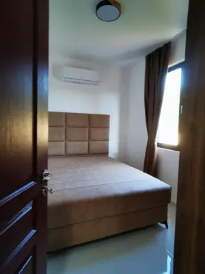 a bedroom with a bed and a window and a door at Visnjeva Gardens in Višnjevo