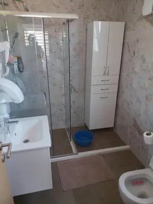 a bathroom with a shower and a toilet and a sink at Apartmani Knezevic in Bar
