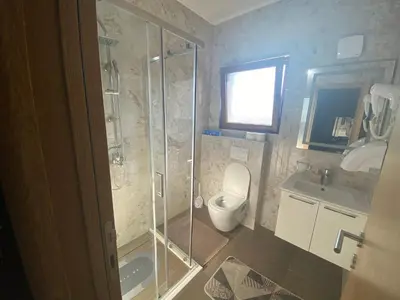 a bathroom with a shower and a toilet and a sink at Apartmani Knezevic in Bar