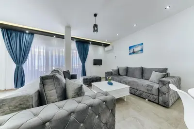 a living room with a couch and a table at Lux DAM Apartments in Bar