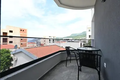 a balcony with two chairs and a table on a roof at Lux DAM Apartments in Bar