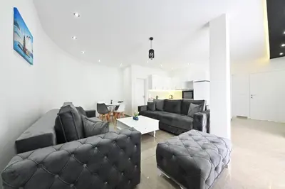 a living room with two couches and a table at Lux DAM Apartments in Bar