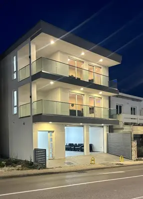 a large white building with a lot of windows at Maja Apartmani in Sutomore