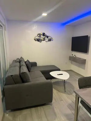 a living room with a couch and a tv at Maja Apartmani in Sutomore
