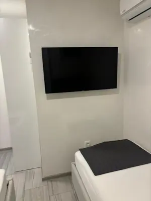 a flat screen tv hanging on a white wall at Maja Apartmani in Sutomore