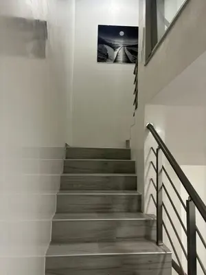 a staircase in a house with a picture on the wall at Maja Apartmani in Sutomore