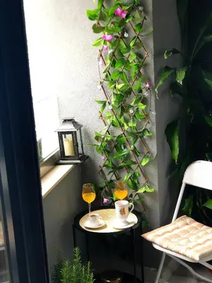 a table with two glasses of wine and a plant at Lavender Apartment - Close to the Beach - Private Garage Parking in Dobra Voda