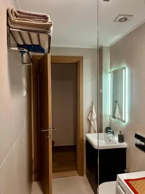 a bathroom with a sink and a glass door at Lavender Apartment - Close to the Beach - Private Garage Parking in Dobra Voda