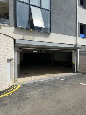 a building with a garage with a yellow hose at Lavender Apartment - Close to the Beach - Private Garage Parking in Dobra Voda