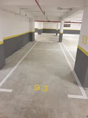an empty parking lot with a yellow number on the floor at Lavender Apartment - Close to the Beach - Private Garage Parking in Dobra Voda