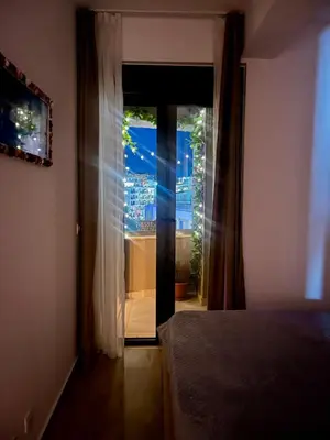 a bedroom with a door open to a window at Lavender Apartment - Close to the Beach - Private Garage Parking in Dobra Voda
