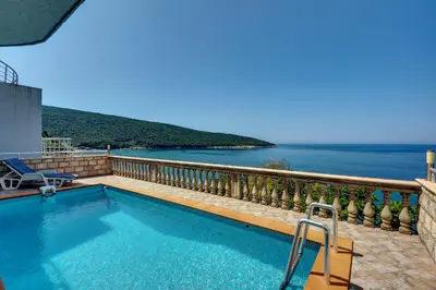 a swimming pool with a view of the ocean at Villa Blue Bay in Kruče
