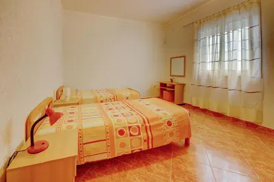 a bedroom with a bed and a window at Villa Blue Bay in Kruče