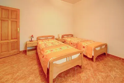 a room with two beds and a door at Villa Blue Bay in Kruče