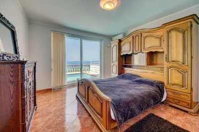 a bedroom with a bed and a large window at Villa Blue Bay in Kruče