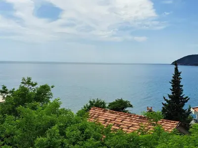 a view of a large body of water with trees at Tinina Basta in Sutomore