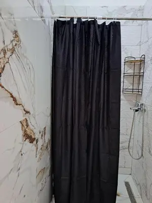 a black shower curtain in a bathroom at Tinina Basta in Sutomore