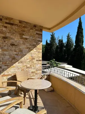 a patio with a table and chairs on a balcony at Casablanca in Sutomore