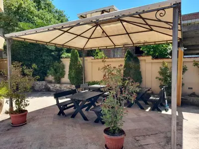 a patio with a picnic table and an umbrella at Casablanca in Sutomore