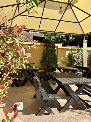 a picnic table and benches under an umbrella at Casablanca in Sutomore