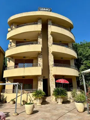 a tall building with plants in front of it at Casablanca in Sutomore