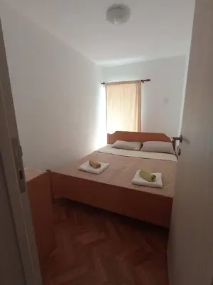 a bedroom with a bed with two towels on it at Apartmani Lakovic in Sutomore