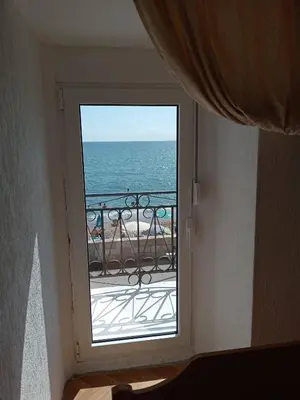 a window in a room with a view of the ocean at Apartmani Lakovic in Sutomore