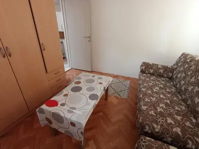a living room with a couch and a table at Apartmani Lakovic in Sutomore