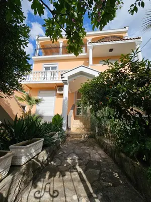 a yellow house with a pathway in front of it at Villa Amela Dubrava in Bar