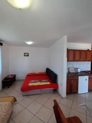 a living room with a red couch in a kitchen at Beli angel in Rafailovici