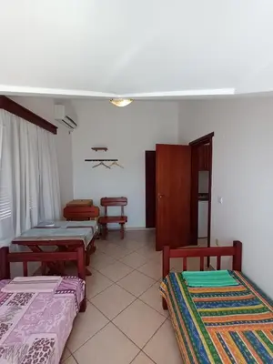 a room with three beds and two chairs in it at Beli angel in Rafailovici