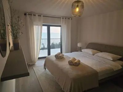 a bedroom with a bed with two towels on it at Villa Drobni Pijesak in Budva