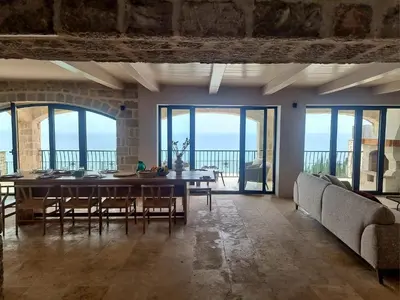 a large dining room with a table and chairs at Villa Drobni Pijesak in Budva