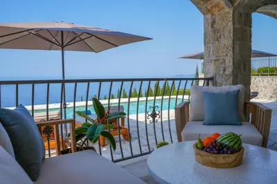 a balcony with a table with a bowl of fruit at Villa Drobni Pijesak in Budva
