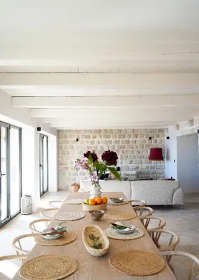 a dining room with a table with plates of food at Villa Drobni Pijesak in Budva