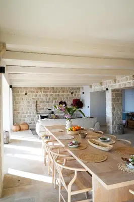 a long wooden table with chairs in a room at Villa Drobni Pijesak in Budva