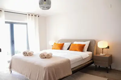 a bedroom with a bed with towels on it at Villa Drobni Pijesak in Budva