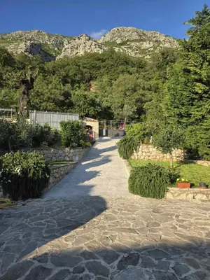 a stone path with a mountain in the background at Villa Drobni Pijesak in Budva