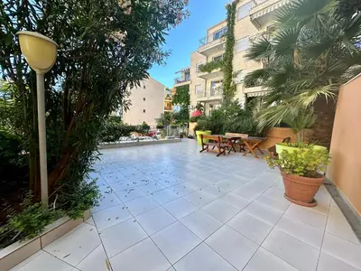 a patio with a table and chairs and plants at Sun Bay Petrovac in Petrovac na Moru