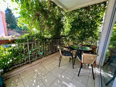 a patio with a table and chairs on a balcony at Sun Bay Petrovac in Petrovac na Moru