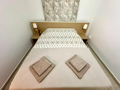 a small room with a bed with two pillows on it at Sun Bay Petrovac in Petrovac na Moru