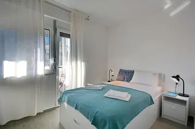 a white bedroom with a bed and a window at Lola - New, best located, elegant & super tidy in Kotor