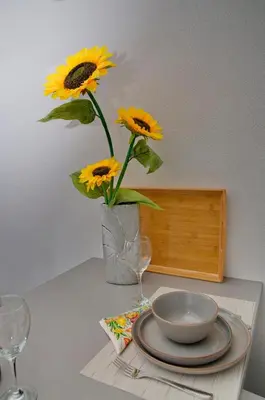 a vase filled with sunflowers sitting on a table at Lola - New, best located, elegant & super tidy in Kotor