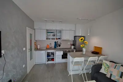 a kitchen with white cabinets and a table in a room at Lola - New, best located, elegant & super tidy in Kotor